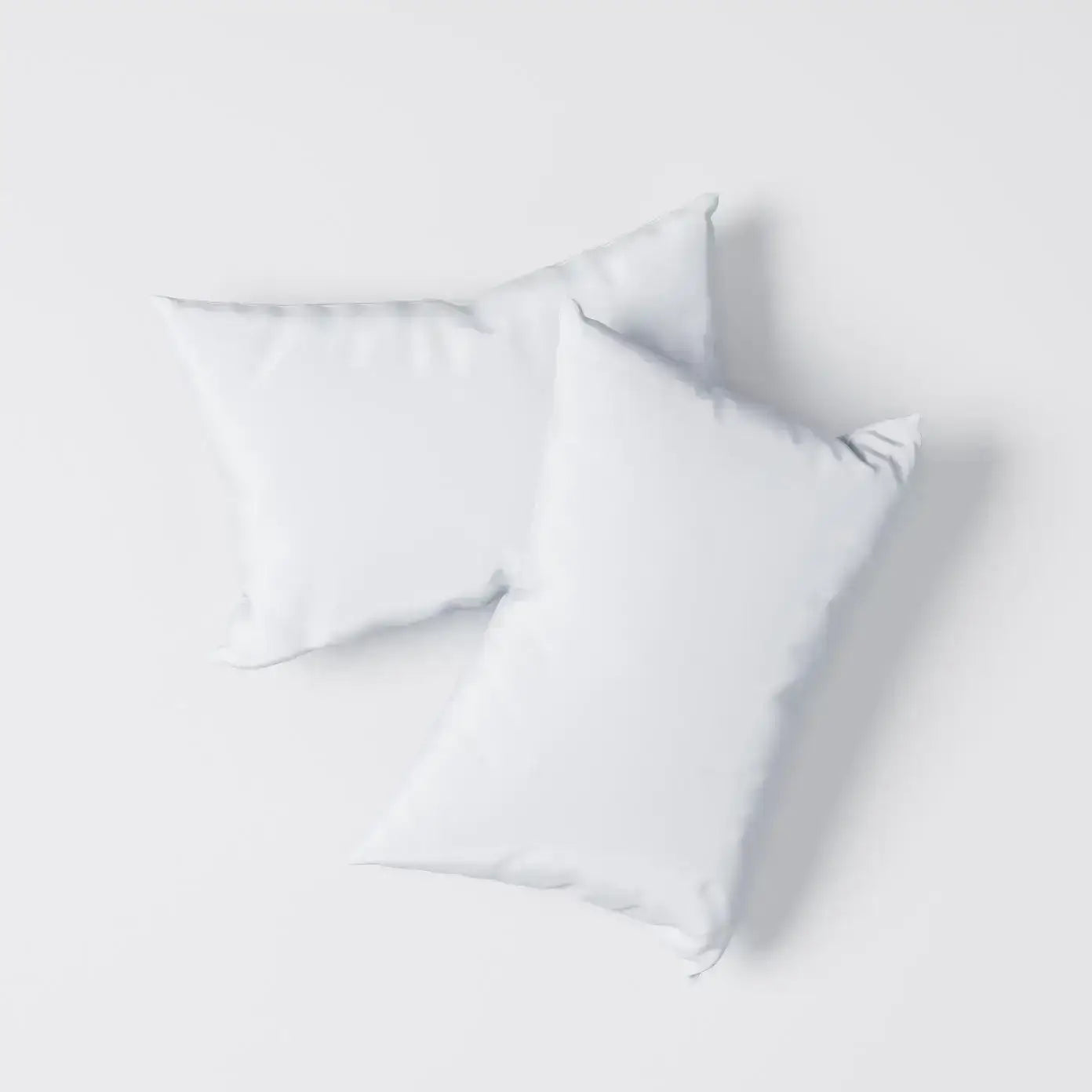 Two soft white pillows designed for comfort and support, ideal for people on medication.