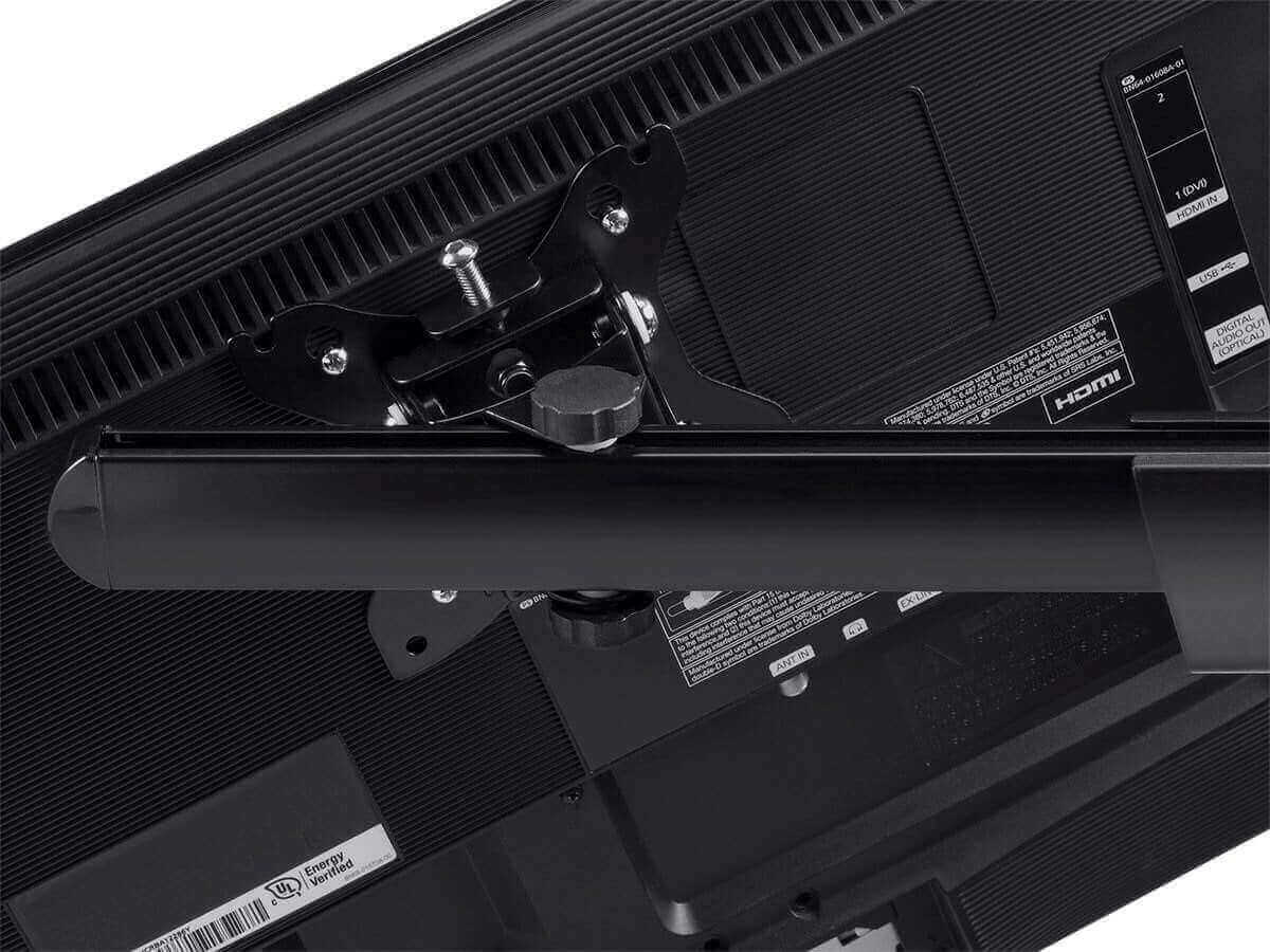 Close-up view of the back of a flat screen TV showing mounting bracket and HDMI connection ports.